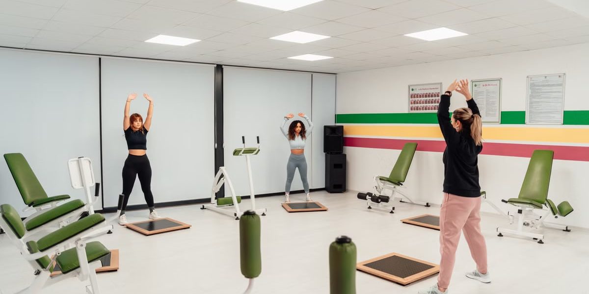 Three women engage in a workout session in a brightly lit, modern fitness studio in Yalova, Türkiye.